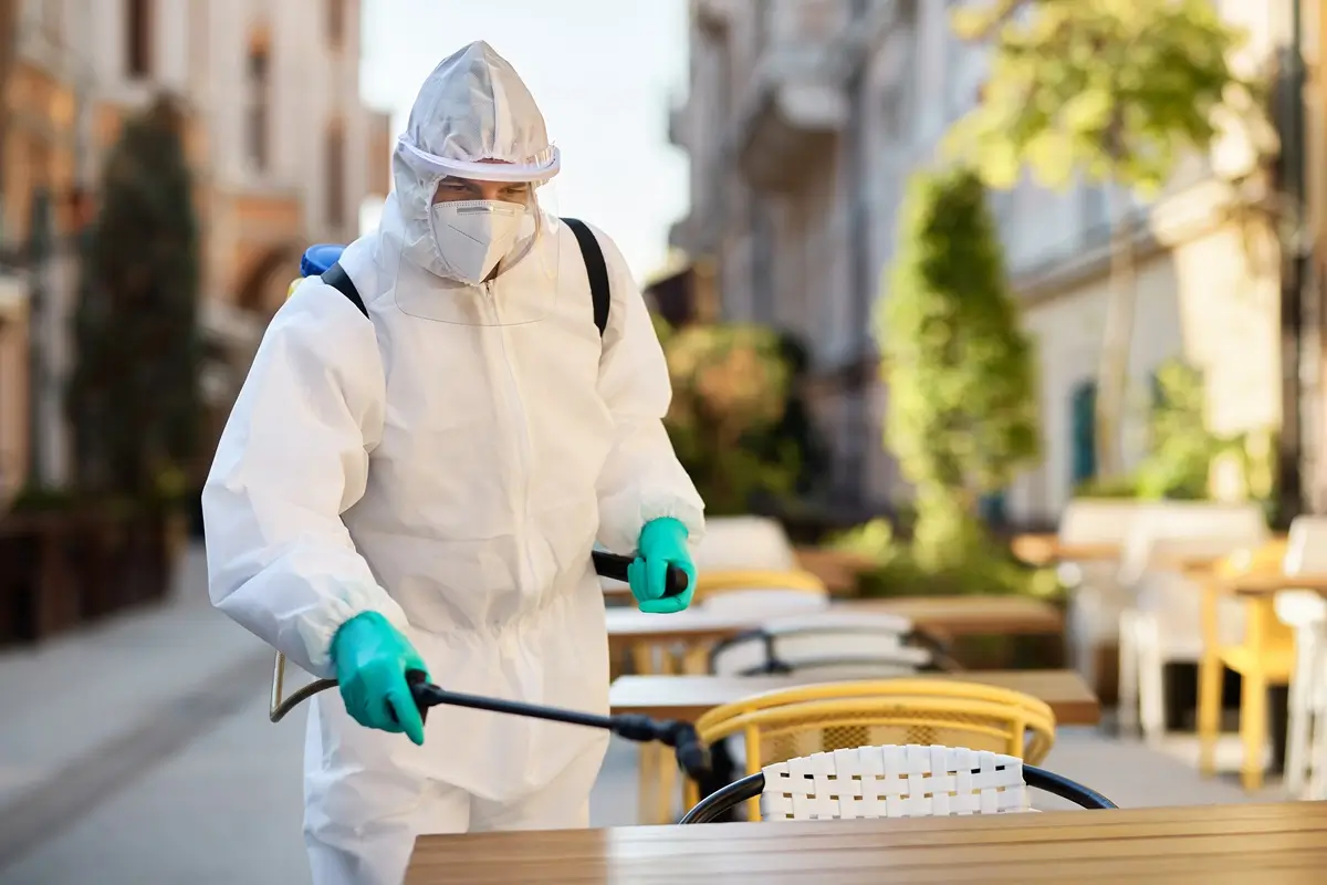 healthcare-worker-hazmat-suit-disinfecting-sidewalk-cafe-covid19-epidemic (1)